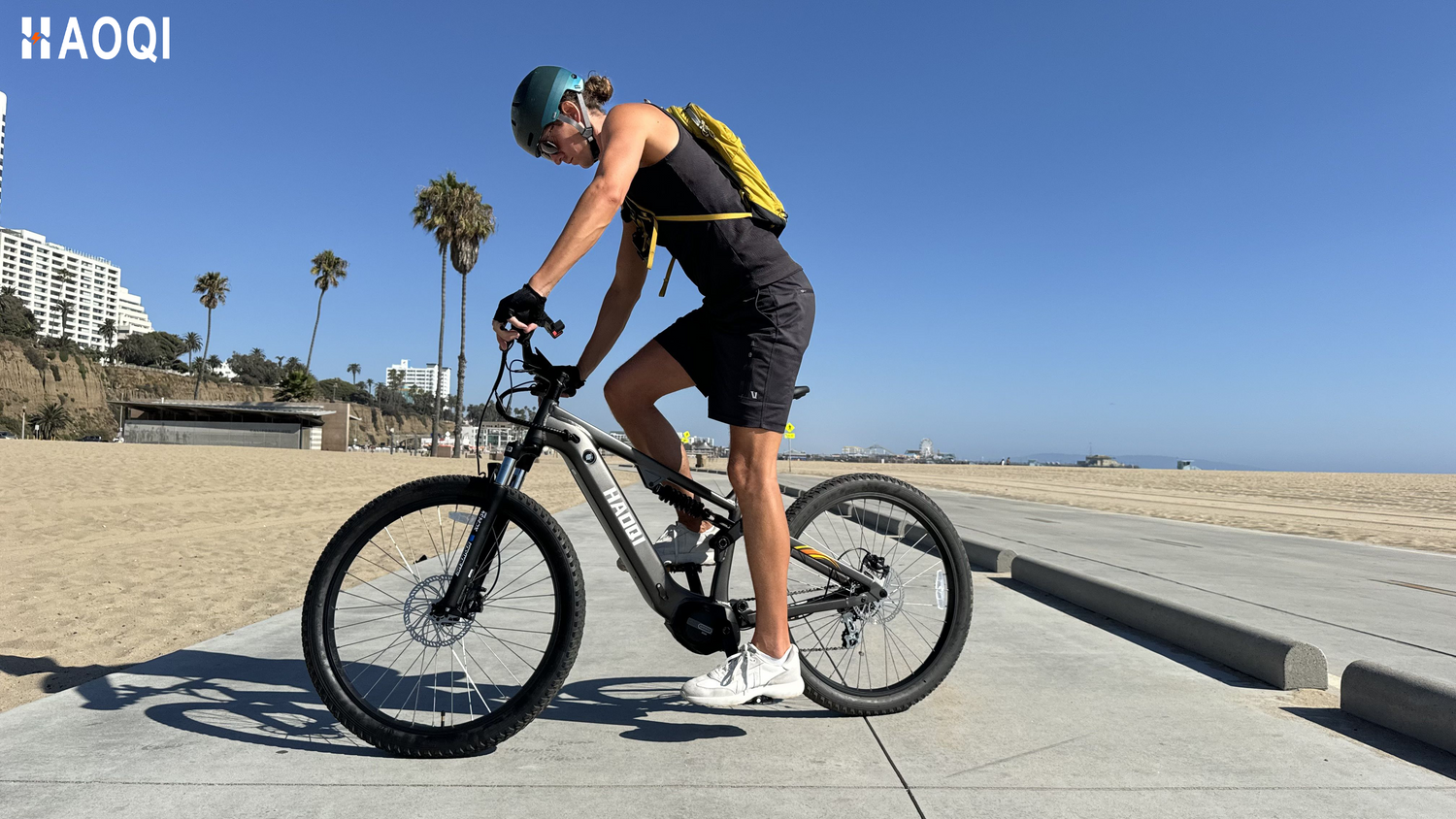 Haoqi Mustang Premium Electric Mountain Bike being ridden on a scenic mountain trail.